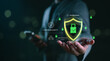 © Looker_Studio - Cybersecurity and data protection concept with businessman holding glowing shield and padlock icon, representing secure network, encryption, digital safety, privacy system and online threat defense.