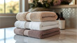 © Naruephu - Neatly folded linen towels stacked with calming tones and clean lines