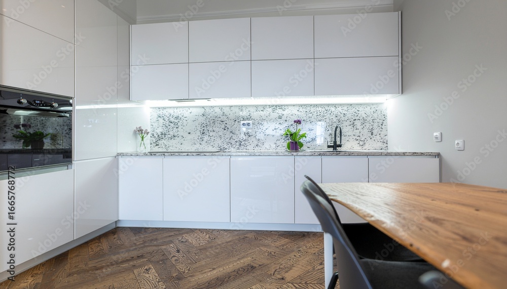 Bright modern kitchen with white cabinets, marble backsplash, and ...