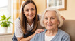 © dubogray1985 - A cheerful female caregiver providing emotional support to a happy elderly woman at home.