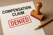 © Piya W. - Personal injury claim denial document with denied stamp and pencil on desk