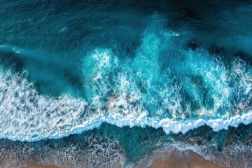 Wall Mural - Vibrant blue ocean waves crashing on sandy beach captured from an aerial perspective during a sunny day showcasing nature's beauty and serene coastal environment