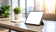 © Nan_Stock - Modern tablet on a clean wooden desk with plants and bright natural light creating a productive atmosphere