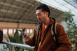 © bernardbodo - Young asian man using smart phone in a train station