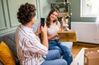 © djoronimo - Adult couple is unboxing their packages delivered to home address. Man is taking photo of new shoes of his woman.