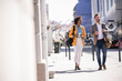 © Westend61 - Business colleagues walking and conversing outdoors in urban city