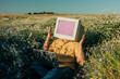 © Westend61 - Business employee with vintage CRT monitor head using laptop in summer meadow