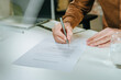 © Westend61 - Businessperson signing employment contract at office desk