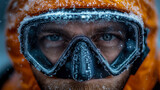 Frozen determination: Intense close-up of intrepid explorer's blue eyes through heavily frosted diving mask, clad in vibrant orange arctic gear amidst harsh, icy environment