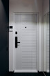 © Kantemir Production - A Modern White Door Featuring a Sleek and Stylish Handle in a Contemporary Hallway Design