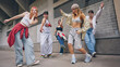 © master1305 - Group of young street dancers performing expressive moves with urban energy. Concept of youth culture, fashion branding, lifestyle promotion, dance schools and social media influence.