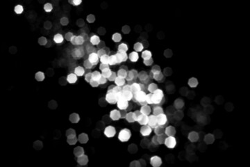 Wall Mural - white gray blurred bokeh lights on black background. glitter sparkle stars for celebrate. overlay fo