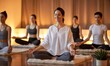 © arif - Yoga class in warm room, five women sit in lotus pose on mats, meditating