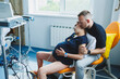 © DSMT - A man supports his wife during childbirth. A man holds his wife's hand in the delivery room. Joint childbirth with a husband. A married couple prepares for the birth of a child.