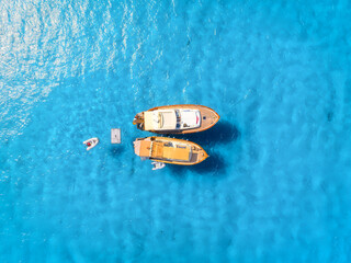Wall Mural - Vacation and leisure. Aerial view on fast boats on blue Mediterranean sea at sunny day. Fast ships on the sea surface. Seascape from the drone. Seascape from air. Seascape with motorboat.