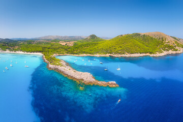 Wall Mural - Drone view of a sea bay with turquoise transparent water. Summer vacation in the Mediterranean. Cala Agulla, Mallorca, Balearic Islands, Spain. Postcard, background, wallpaper.