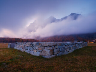 Wall Mural - mountain landscape at dawn. sunbeams in a valley. foggy weather in the mountain valley at dawn. natu
