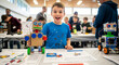 © Anisgott - Young Innovator and his Robot: A young boy beams with pride as he presents his handcrafted robot creation, embodying the spirit of innovation and childhood fascination with technology.