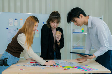 a team of developers collaborates to plan uxui designs, working on wireframes for website and mobile