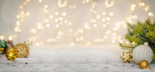 Wall Mural - christmas holiday background with snow, fir tree and decorations with christmas light behind. christ