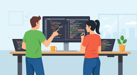 Two coders reviewing code on a large screen laptops on desk office setting