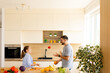 © BGStock72 - Fun moments of juggling fruits in a modern kitchen with family joy