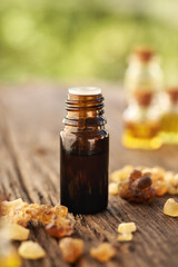 Wall Mural - A brown bottle of frankincense essential oil with frankincense resin