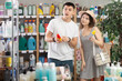 © JackF - Spouses examines product mosquito repellent while purchase in store. Customer near display case looks at product, pays attention to features and manufacturer