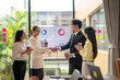 © Apichat - Business people shaking hands during meeting in modern office