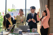 © Apichat - Real estate agents celebrating closing a deal in the office