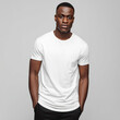 © Surachetsh - A Black man in a plain white t shirt stands against a neutral background. The blank shirt is ideal for clothing mockup and fashion display.
