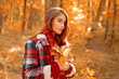 © Volodymyr - Woman walking through Autumn falling leaves. Romantic portrait of girl on yellow fall foliage. Beautiful woman holding a maple leaf. Caucasian girl on autumn outdoors. Outdoor lifestyle with fall