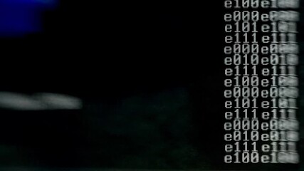 Abstract binary code data stream in digital stream of bits and bytes flow on dark background