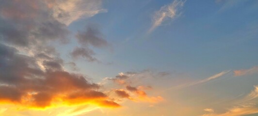 Wall Mural - Panorama sunrise sky with vibrant colorful clouds. Beautiful early morning sky in wide landscape view. Sunrise and clouds in the morning.