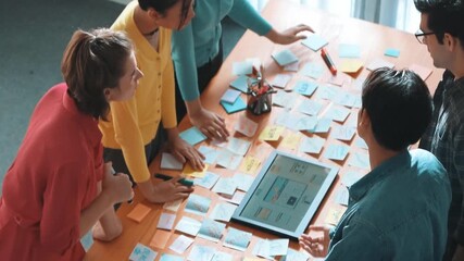 Top view of skilled programmer brainstorming idea about mobile phone interface while develop app development by using wireframe prototype. Web designer planning at table with sticky notes. Symposium.