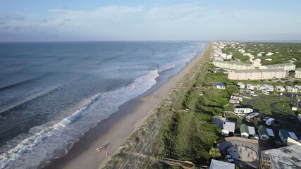 Wall Mural - drone shot of ocean swells coming in from a hurricane offshore, wide aerial shot with beach homes