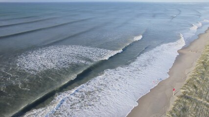 Wall Mural - drone shot of ocean swells coming in from a hurricane offshore, wide aerial shot