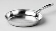 © Udin - Sleek, stainless steel frying pan with a long handle on a light, neutral surface