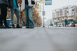 © qunica.com - A group of friends wearing casual attire standing together on an empty urban sidewalk at dawn, surrounded by residential buildings and light vehicular traffic.