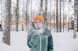 © Amparo Garcia - Young girl blowing snow in a winter forest