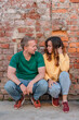 © KseniaJoyg - An adult man and woman in love at a brick wall outside