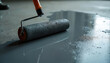 © Viktor - Roller applies grey sealant to concrete floor surface. Protects, coats, and smooths industrial or home improvement projects. Seamless, hard-wearing finish for durable flooring.