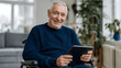 © Iana - cheerful senior man in wheelchair, holding  tablet, smiling broadly
