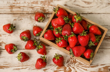 Wall Mural - box with sweet fresh strawberries on white wooden background