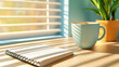 © kampolsuk - Morning sunlight casts soft shadows on tidy wooden desk with closed spiral notebook, ceramic coffee cup, and potted plant, creating calm and inviting workspace atmosphere