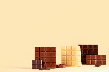 Wall Mural - Different sweet chocolate bars on beige background