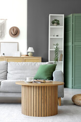 Poster - interior of light living room with grey sofa, table and shelf unit