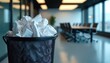 © Viktor - Crumpled papers fill rubbish bin in modern office meeting room. Represents failed business ideas, need for teamwork, problem-solving, refining concepts to foster innovation, persistence for success.