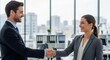 © Margarita Ratatosk - A man and a woman shaking hands, representing business agreement and partnership for financial success and investment.