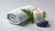 © pkproject - Peaceful spa scene with towel, leaves, and candle